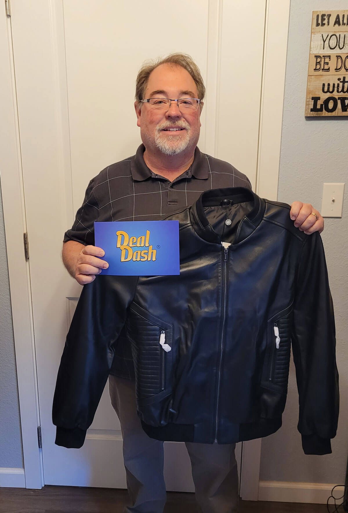 A member holding the leather jacket he won